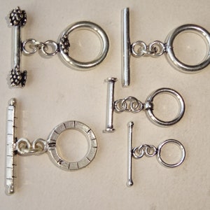 May include: Six silver toggle clasps with different ring styles. The clasps are made of metal and have a polished finish.