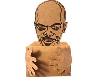 May include: A cardboard cutout of a person's head with a smiling expression. The head is attached to a cardboard box with arms that are outstretched and appear to be hugging the box.