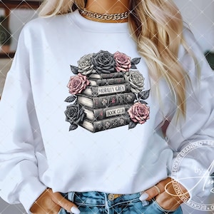 May include: White sweatshirt with a graphic of a stack of books with the text "Morally Grey Book Club" and floral accents.