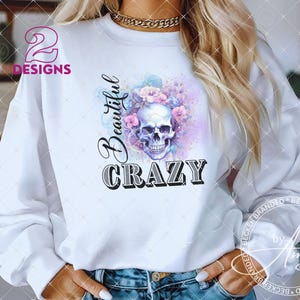 May include: White sweatshirt with a floral skull graphic and the text "Beautiful Crazy".