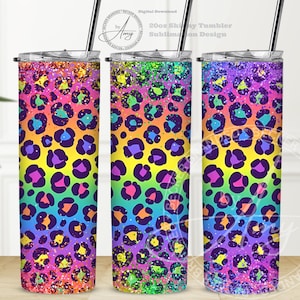 May include: Three 20oz skinny tumblers with a rainbow leopard print design. The tumblers are covered in glitter and have a colorful, vibrant design.