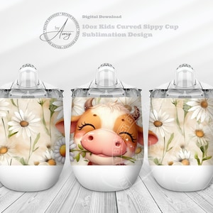 Könnte beinhalten: Drei 10 Unzen weiße Edelstahl-Trinkbecher mit klaren Deckeln. Die Becher zeigen ein Sublimationsdesign einer Comic-Kuh mit braunen und weißen Flecken, die einen Zweig weißer Gänseblümchen hält. Der Hintergrund ist ein Aquarelldesign aus weißen Gänseblümchen auf beigefarbenem Hintergrund.