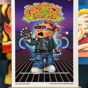 May include: A trading card featuring a cartoon character with a green and purple background. The character is wearing a plaid shirt, blue jeans, and a headset. The text "GAME OVER" is displayed on the headset. The card is numbered 12 and has the text "GPK and WACKY WAREHOUSE" at the bottom.