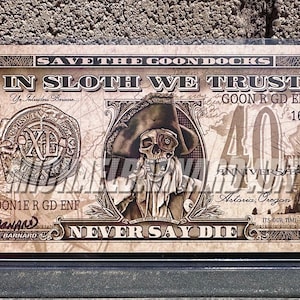 May include: A novelty $40 bill with a skull and crossbones design. The bill reads "Save the Goon Docks" and "In Sloth We Trust".