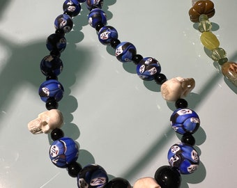 Glass face beads with carved skull necklace