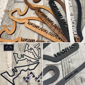 May include: Wooden track layouts in walnut, oak, and cherry. Black, white, and gray track name signs with "PORTLAND RACEWAY" and "MUGIELLO" text. Circuit size options include "Supersize", "Large", "Medium", and "Mini".
