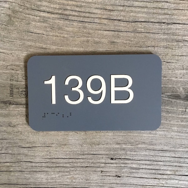 Interior room number sign, raised plastic lettering, Braille