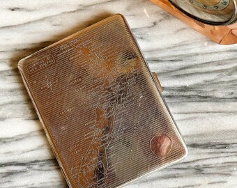 Antique metal cigarette case with map of New Zealand engraved on front