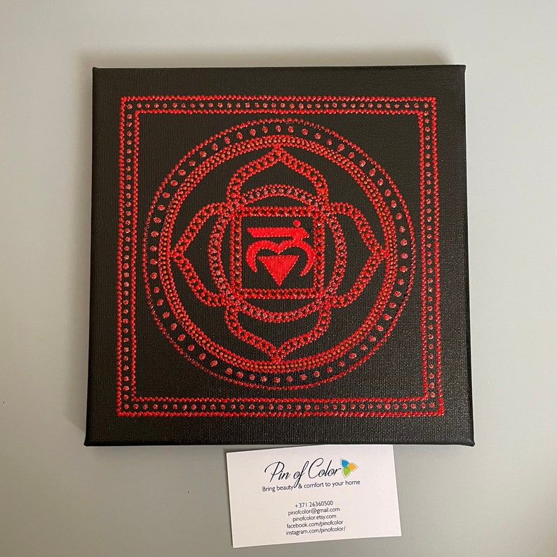 May include: Red and black canvas painting of the Anahata chakra, the heart chakra, with a mandala design. The painting is made with red dots on a black background.