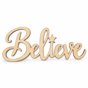 May include: A light-colored wooden cutout featuring the word Believe in a cursive script font. The letter i is replaced by a five-pointed star shape. The object has a smooth, natural wood grain finish and is presented against a plain white background.