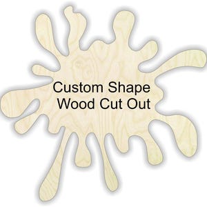 May include: A custom-shaped wood cut out in a light wood color. The shape resembles a stylized splash or blot. The text "Custom Shape Wood Cut Out" is printed in black, centered on the wood cutout. The wood grain is visible.