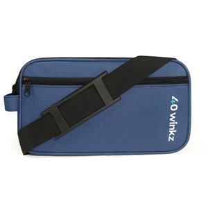 May include: A blue zippered travel bag with a black adjustable strap and the text "40 winks" embroidered on the front.