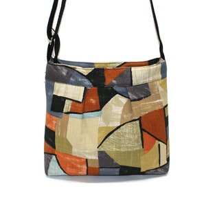 Geometric canvas fabric small crossbody bag with zipper closure, adjustable strap and inside pocket