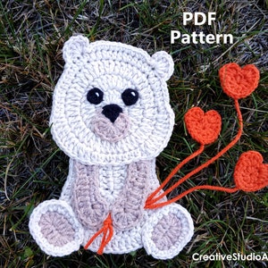 May include: Crochet pattern for a white bear holding three red hearts. The pattern is available as a PDF download. The text "PDF Pattern" is visible in the image.