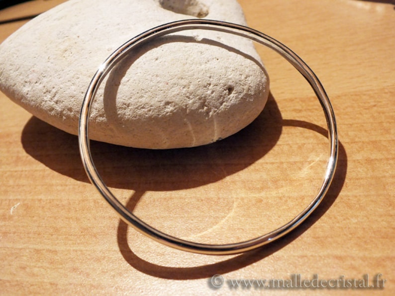 May include: A simple silver bangle bracelet, a classic and timeless piece of jewelry.