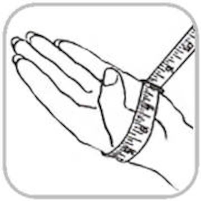 May include: A measuring tape wrapped around a person's wrist to measure the circumference.