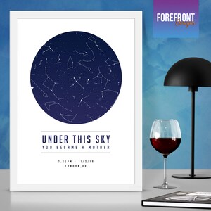 May include: A white framed print with a navy blue circle depicting a constellation of stars. The text "Under this sky you became a mother" is printed below the circle, along with the date and time "7:25PM - 11/2/18" and the location "LONDON, UK".