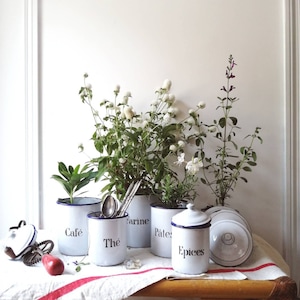 Vintage enamelled spice pots, kitchen decoration and storage, old white metal boxes.