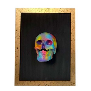 May include: A colourful, rainbow-painted skull with a black moustache in a gold frame.