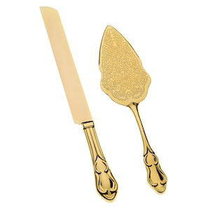 May include: A gold-colored cake knife and server set with ornate handles. The server has a decorative, floral design.