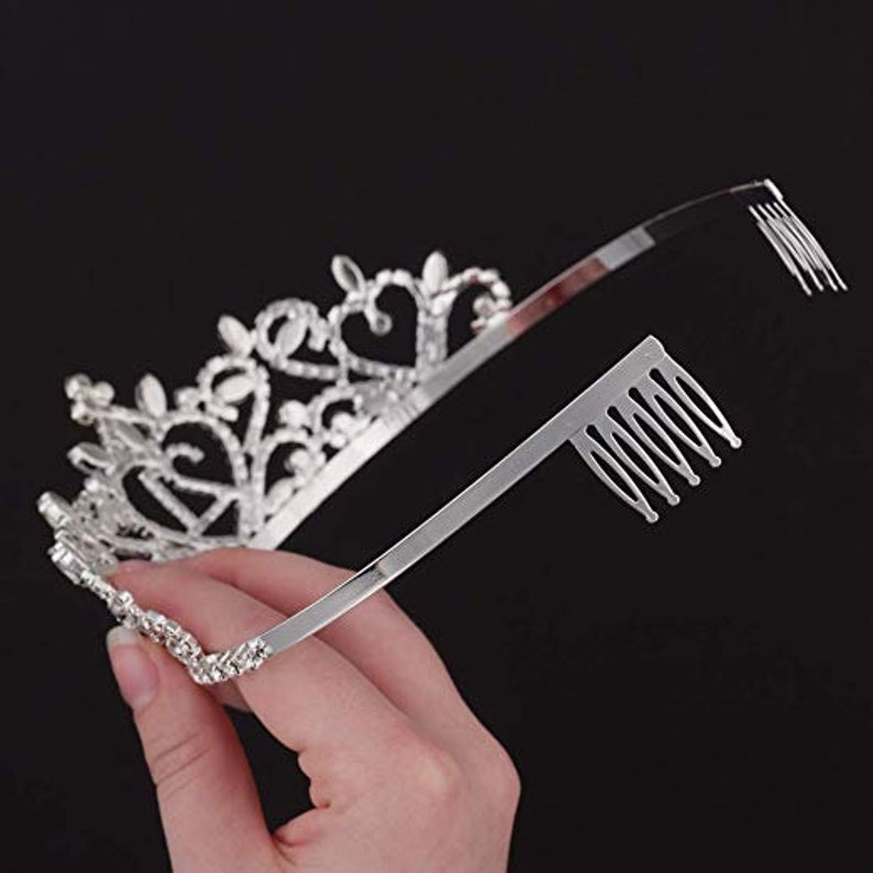 May include: Silver tiara with a crystal design and a comb on the back for easy attachment.