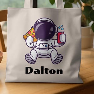 Bonita bolsa de astronauta, regalo para amantes del espacio, divertida bolsa espacial, astronauta kawaii comiendo pizza, bolsa con diseño de astronauta de dibujos animados, bolsa reutilizable