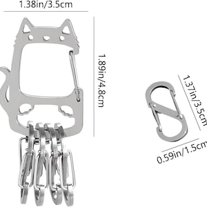 May include: A silver-colored cat-shaped keychain with a carabiner clip and multiple key rings. The cat keychain measures 1.89 inches (4.8 cm) in height and 1.38 inches (3.5 cm) in width. A separate silver carabiner clip is also shown.