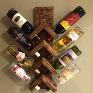 May include: A wooden wine rack with a "Wine Time" sign. The rack is mounted on a wall and holds eight bottles of wine. The bottles are arranged in a staggered pattern, with the necks of the bottles facing outward.