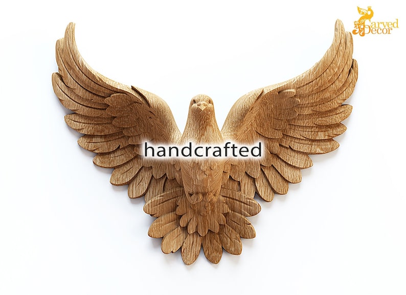 May include: A handcrafted wooden dove sculpture with outstretched wings. The bird is carved from light-colored wood, showcasing detailed feather textures. The word "handcrafted" is displayed across the center. A decorative piece for wall decor.