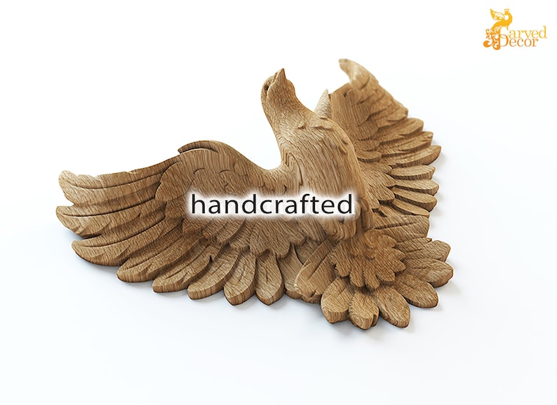 May include: A handcrafted, wooden carving of an eagle in flight. The eagle is depicted with outstretched wings and detailed feathering. The text "handcrafted" is visible on the carving. The carving is a light brown color and is set against a white background.
