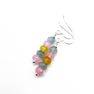May include: Silver dangle earrings with a cascade of pastel pink, blue, and yellow faceted beads.