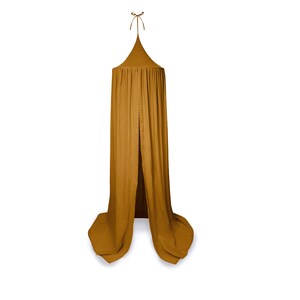May include: Mustard-coloured canopy with a conical top and flowing fabric. The canopy is suspended from a single point, with a tie at the top. The fabric drapes down, creating a soft, inviting space. Suitable for a child's bedroom or play area.