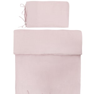 May include: A pink linen duvet cover and pillow sham set with ties at the corners.
