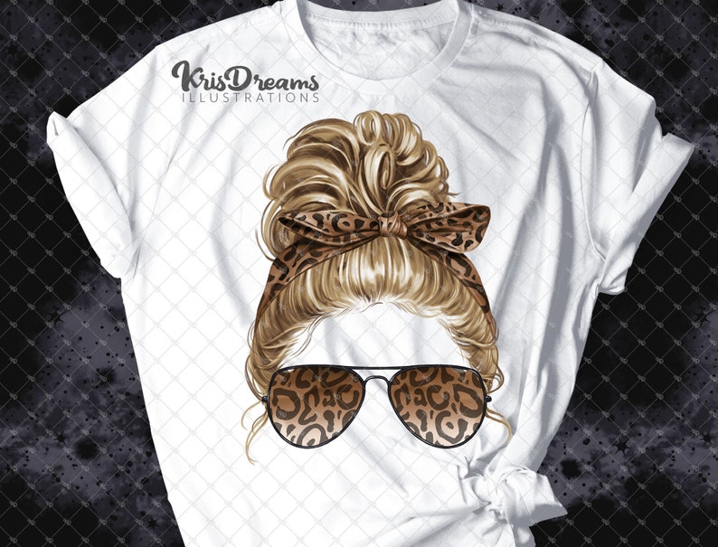 May include: A white t-shirt with a graphic of a woman with blonde hair in a messy bun, wearing leopard print sunglasses and a headband. The text "KrisDreams Illustrations" is printed on the shirt.