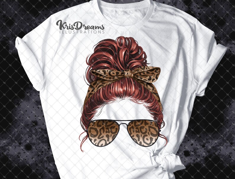 May include: A white t-shirt with a graphic of a woman with red hair in a messy bun wearing leopard print sunglasses and a headband. The text "KrisDreams Illustrations" is printed on the shirt.