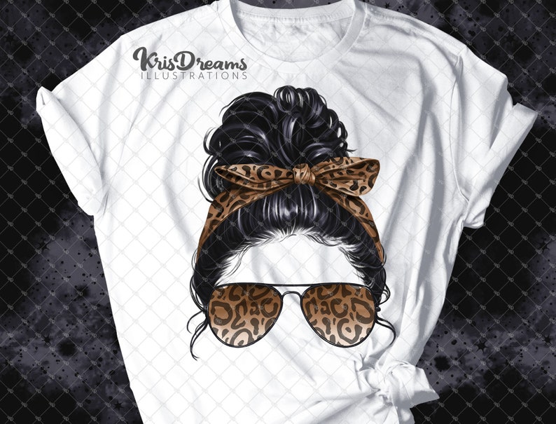 May include: White t-shirt with a graphic of a woman with black hair in a messy bun, wearing leopard print sunglasses and a leopard print headband. The text "KrisDreams Illustrations" is at the top of the shirt.
