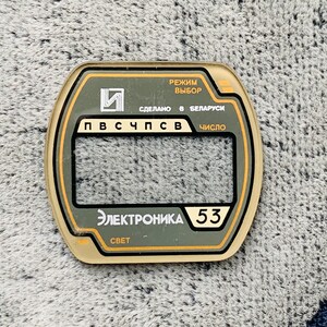 May include: A rectangular electronic component with a clear window and text in Russian. The component has a green and gold color scheme, with the text "Электроника 53" and "СВЕТ" visible.