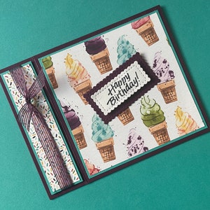 May include: A white ceramic mug with a black handle and the text "But First, Coffee" in a black, bold font. The mug is sitting on a white surface. The mug is approximately 4 inches tall.