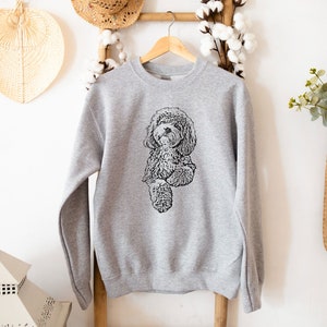 May include: A gray sweatshirt with a black and white illustration of a dog on the front.
