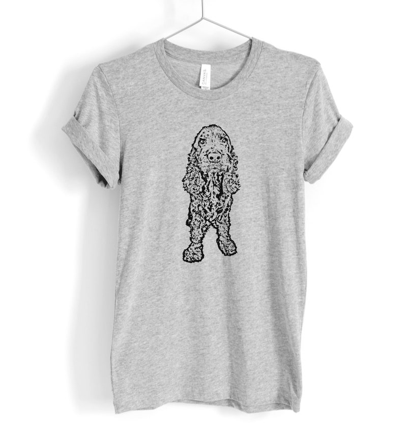May include: A gray t-shirt with a black and white illustration of a Cocker Spaniel dog.
