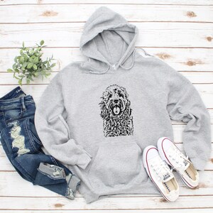 May include: Gray hooded sweatshirt with a black and white illustration of a doodle dog on the front.