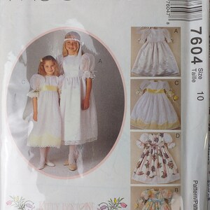 May include: McCall's sewing pattern envelope featuring illustrations of girls' dresses. The envelope includes the text "McCall's" and "Kitty Benton Gourmet Sewing". The pattern number is 7604, size 10.