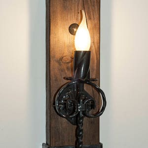 Rustic wall light. Wood and wrought iron