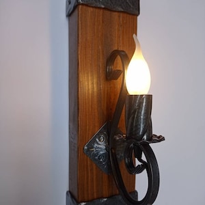 Rustic wall light. Wood and wrought iron sconce.