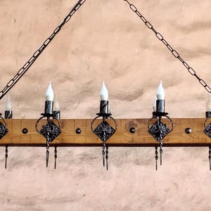 Large chandelier lights. Wrought iron and wood beam 10 light fixture