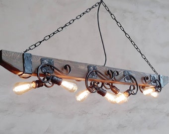 May include: A rustic wooden and metal chandelier with six light bulbs. The chandelier is suspended from a chain and has a dark wood beam with metal accents.