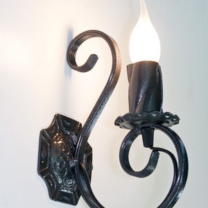 Wrought iron wall light. Wall sconce. Candelabra sconce