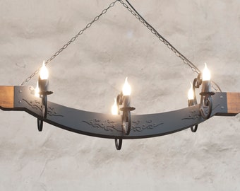Six light chandelier lighting. Black metal and wood light. Wrought iron chandelier.