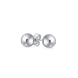 May include: A pair of silver ball stud earrings. The earrings are simple and elegant, and they would make a great gift for any occasion.