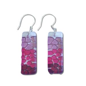 May include: A pair of silver dangle earrings with rectangular pink and purple glass mosaic designs.